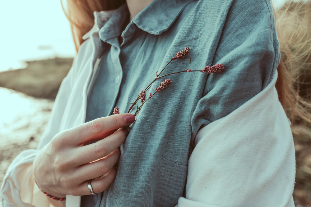 A,Close-up,Of,Woman's,Hand,Holding,A,Wild,Flower.,A