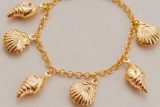 Elegant Gold Seashell Bracelet on Neutral Background