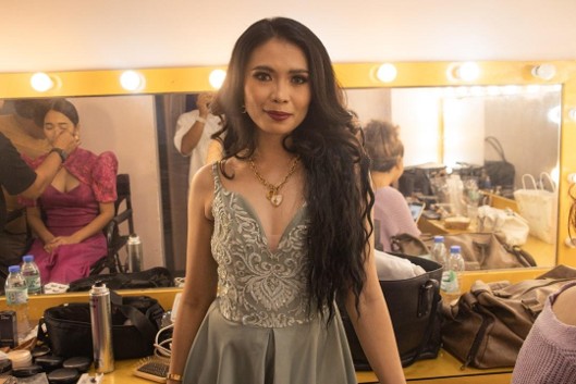 Young woman in an elegant dress getting ready for a dance